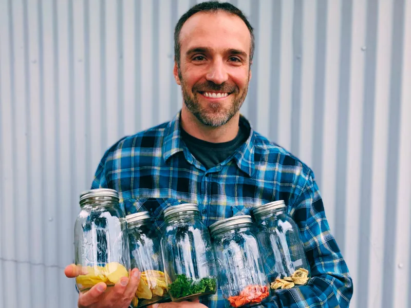 Author holding his dehydrated food in jars
