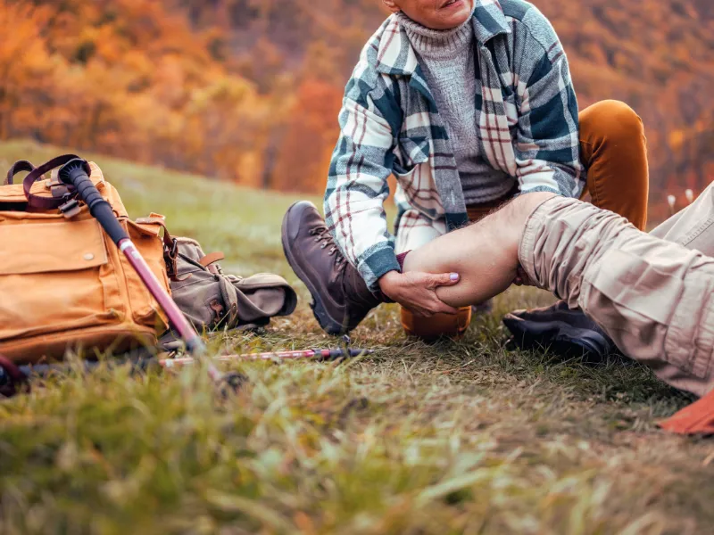 Hiker providing first aid to fellow hiker