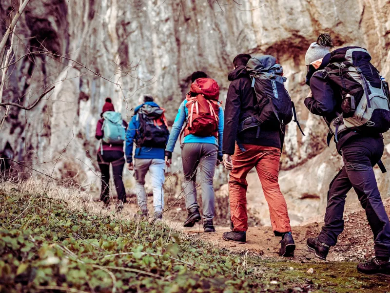 Group of hikers walking up a trail