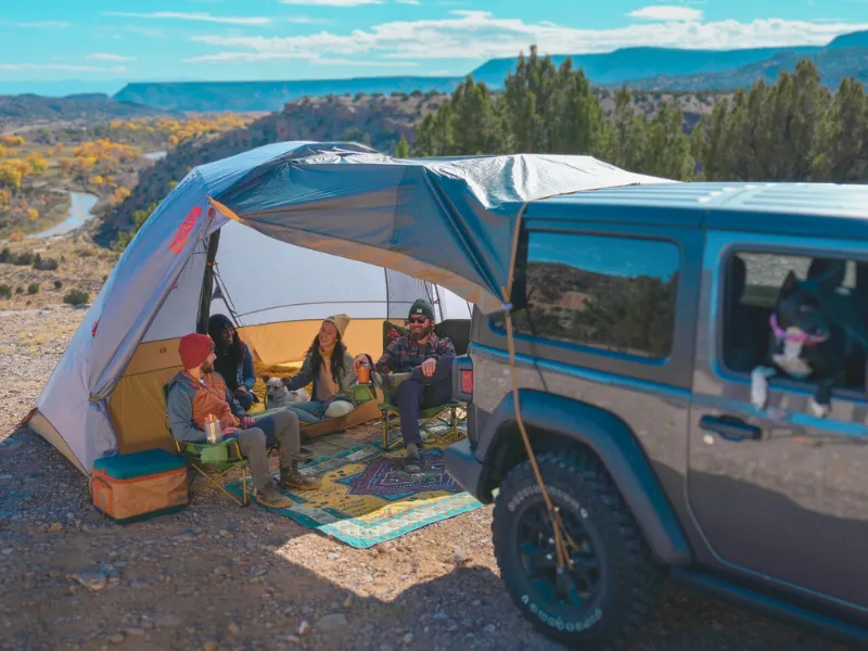Friend camping with their Jeep attached to their Kelty Caboose SUV tent. 
