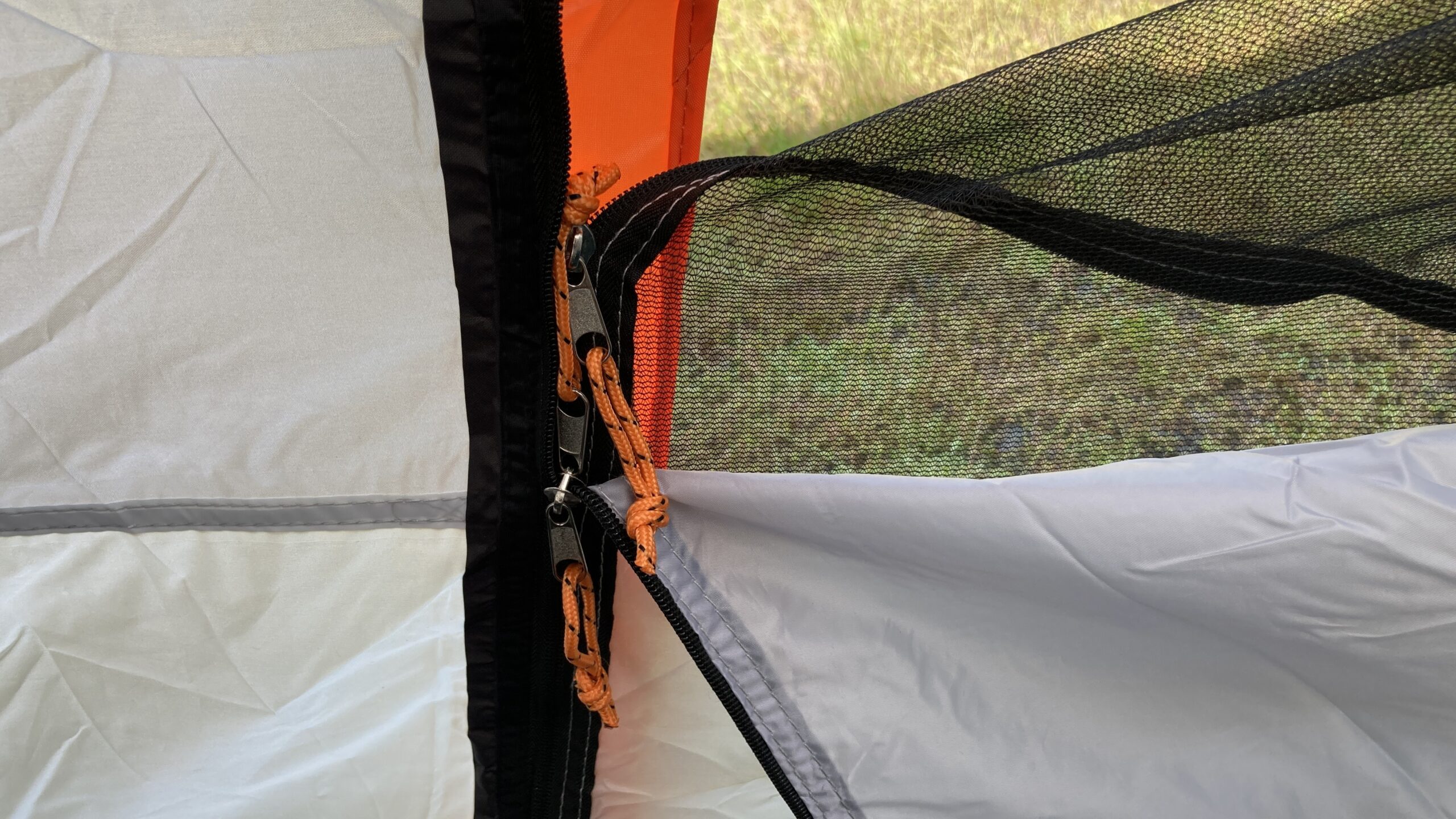 Close view of the 2 door zipper sliders and their cord pulls